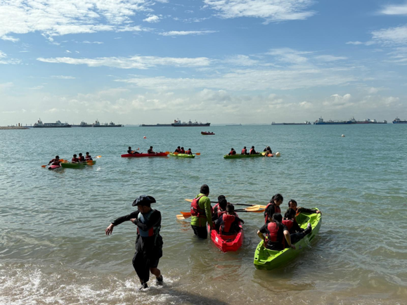 Students kayaking together during an outdoor learning programme.